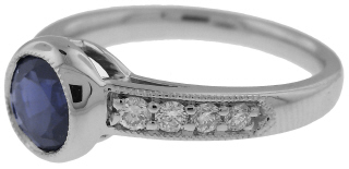 Platinum bezel set sapphire and diamond ring