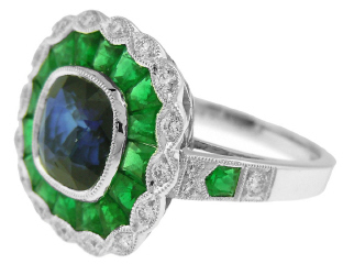 Platinum bezel set sapphire, emerald, and diamond ring