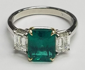 Platinum/18kt yellow gold emerald and diamond 3-stone ring.