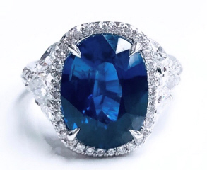 Platinum oval sapphire and diamond halo ring