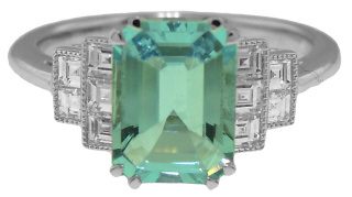 Platinum emerald cut aqua and square diamond ring.