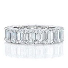 Platinum shared prong emerald cut diamond eternity band with airline.