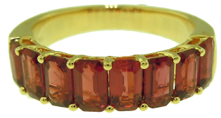 18kt yellow gold shared prong emerald cut ruby band.