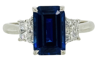 18kt white gold emerald cut sapphire and traps diamond ring