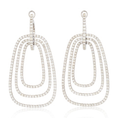 18kt white gold triple ring diamond dangle earrings.