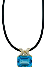14kt yellow gold diamond and blue topaz pendant with black rubber cord